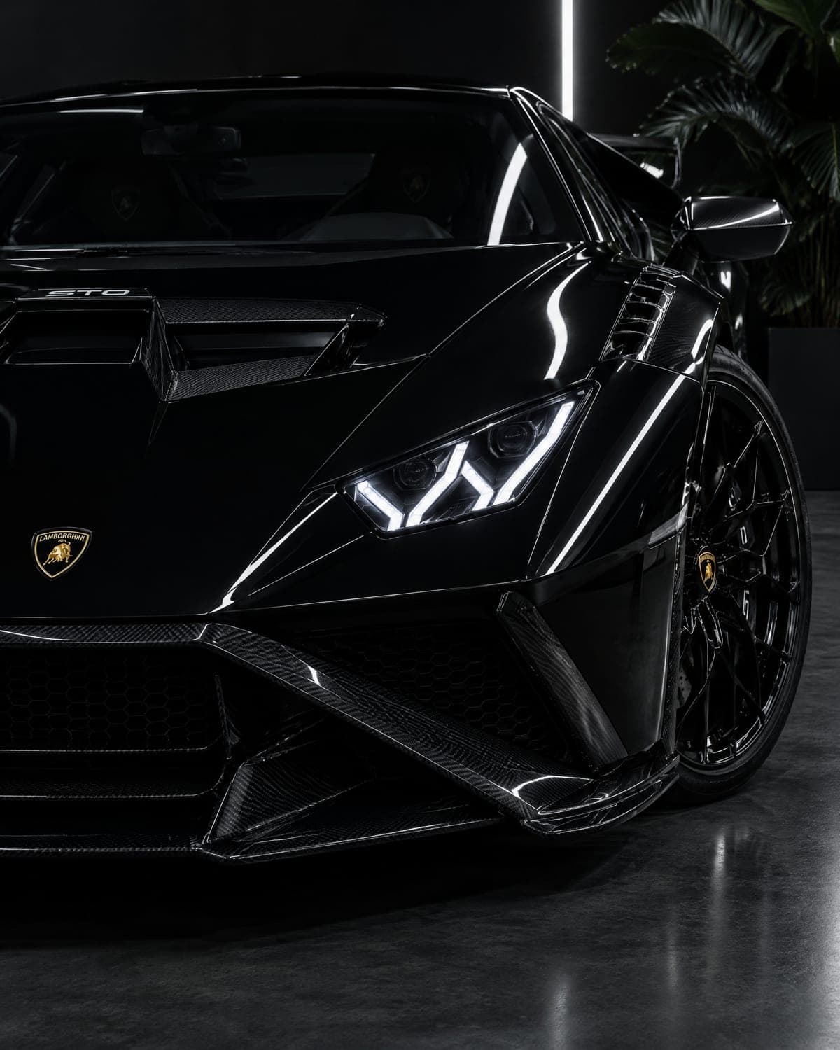 Front corner of a black Lamborghini Huracán STO