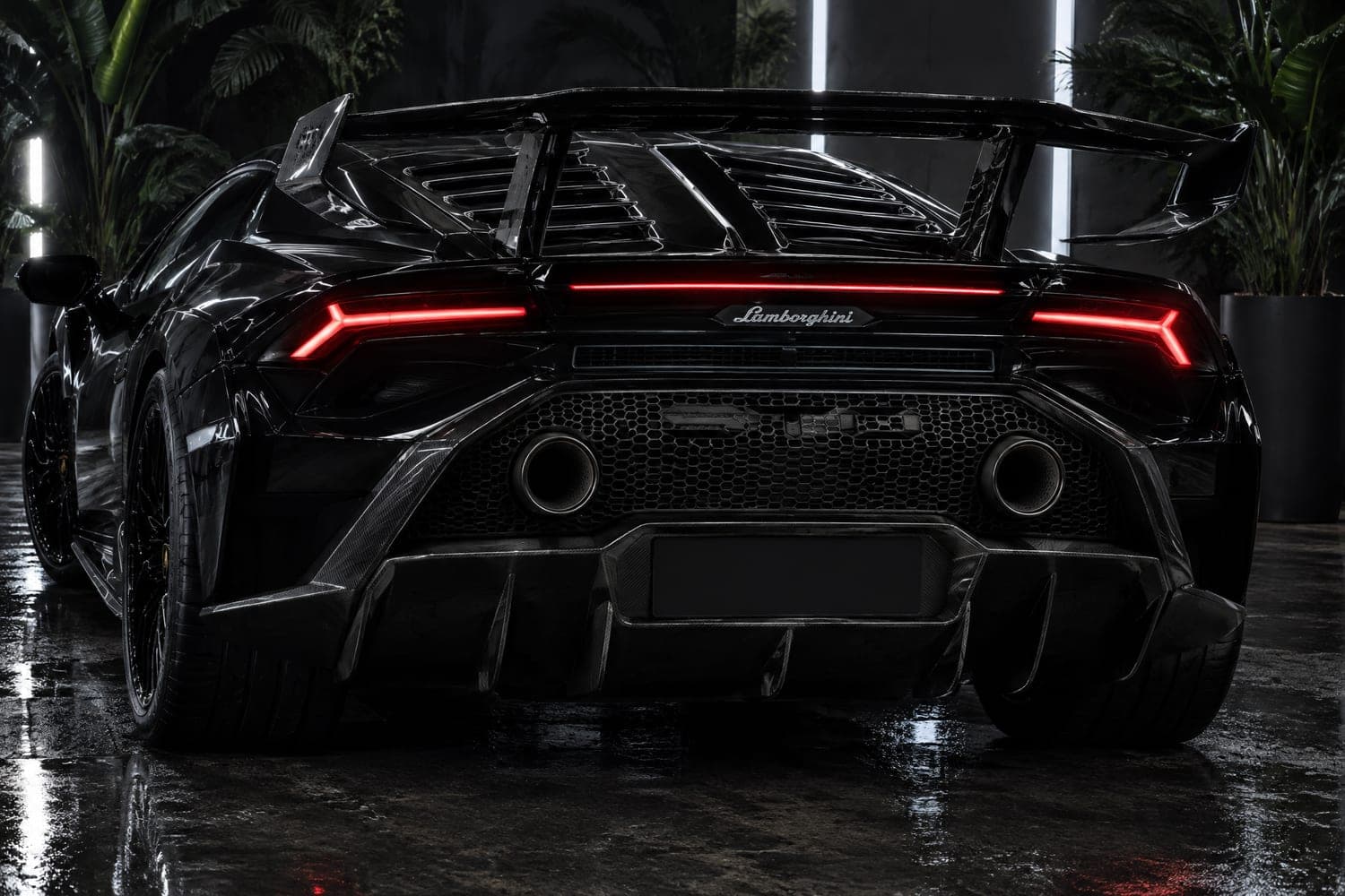 Rear three-quarter of a black Lamborghini Huracán STO