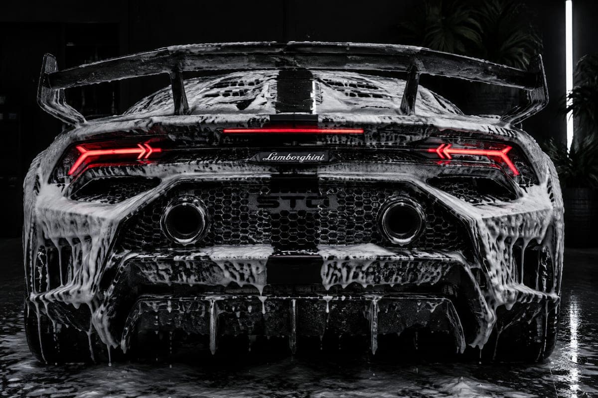Thick snow foam on a black Lamborghini during a hand wash