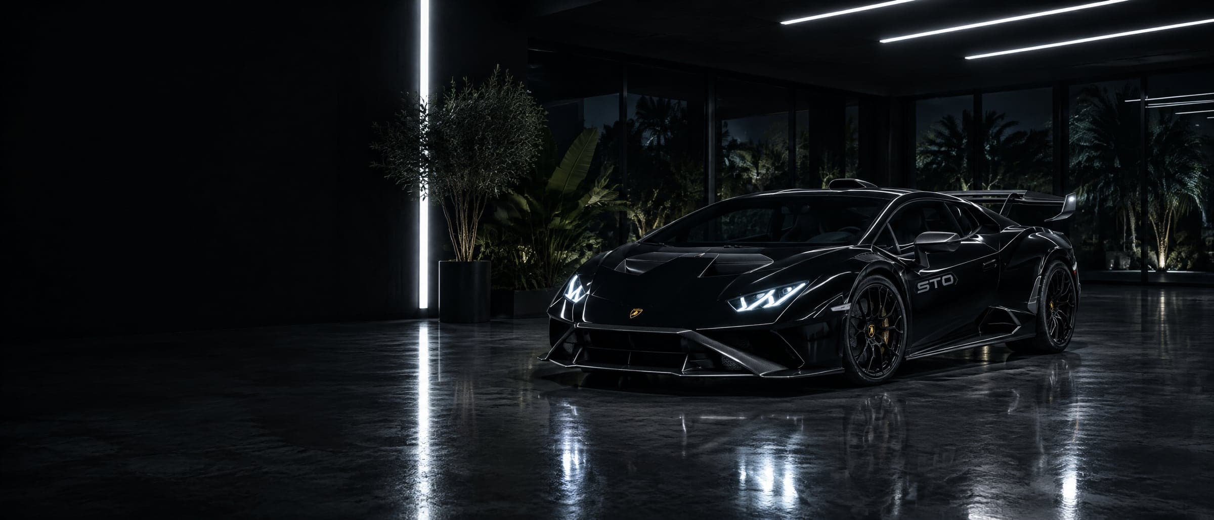 A gloss black Lamborghini Huracán STO in a dark studio, lit by strips of cool light